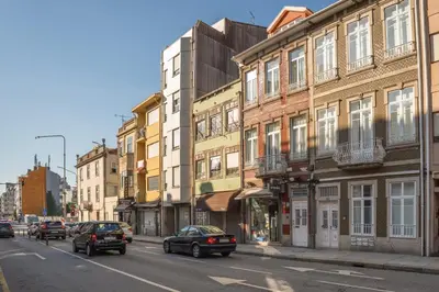 a city street with cars driving down a street with buildings at Cozy Studio with Workspace by HostWise in Porto