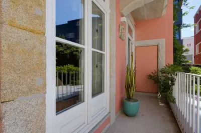 a house with a white door and a cactus on a balcony at Quinta dos Cedros Garden & Terrace in Porto