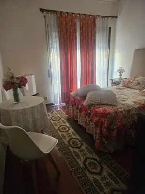 a bedroom with a bed and a table and a chair at Apartamento Quarto Compartilhado Porto in Porto