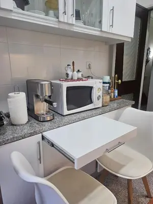 a kitchen with a microwave on a counter at Apartamento Quarto Compartilhado Porto in Porto