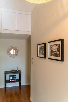 a room with two pictures on the wall and a table at São João by Casa de Gondomil in Porto