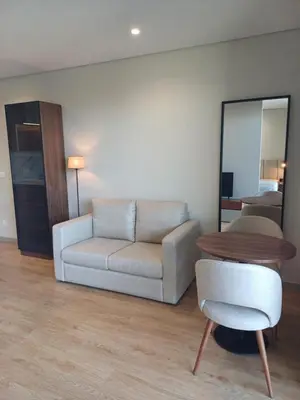 a living room with a couch and a table and a mirror at Blue River - Douro Tower in Vila Nova de Gaia