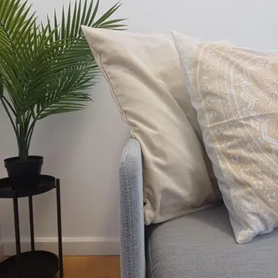 a pillow on a bed next to a potted plant at Your Home in Porto 1480 Style and Comfort in Porto