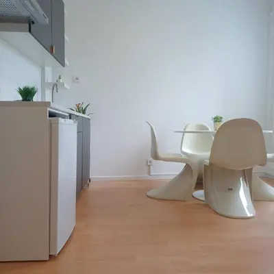 two white chairs in a room with a kitchen at Your Home in Porto 1480 Style and Comfort in Porto