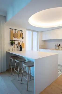 a kitchen with a blue counter and stools at My Home is Yours in Porto