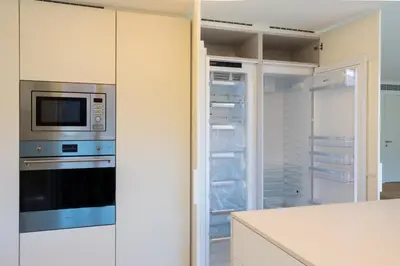 a kitchen with a stove and a microwave at My Home is Yours in Porto