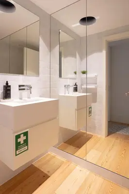 a bathroom with two sinks and a mirror at My Home is Yours in Porto
