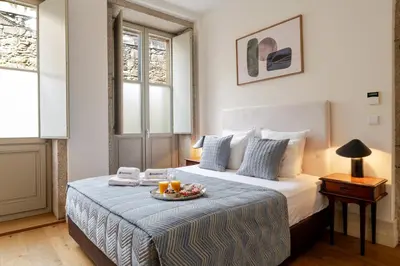 a hotel room with a bed with a tray of fruit on it at Central & Cozy Studio by HostWise in Vila Nova de Gaia