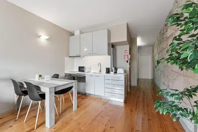 a kitchen and dining room with a table and chairs at GuestReady - Peaceful retreat in Porto in Porto