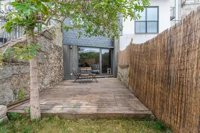 a wooden walkway leading to a house with a fence at GuestReady - Peaceful retreat in Porto in Porto