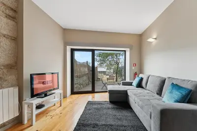 a living room with a couch and a tv at GuestReady - Peaceful retreat in Porto in Porto