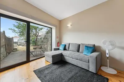 a living room with a couch and a large window at GuestReady - Peaceful retreat in Porto in Porto