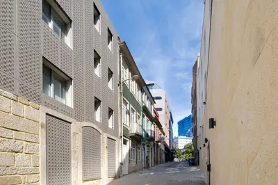 an empty street in a city with buildings at Trindade Essence Duo Suites in Porto