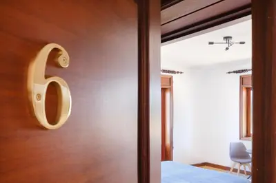a door with a large letter b on a wall at Villa 7BR & 7BA with Pool & Backyard in a Prime Location! in Vila Nova de Gaia