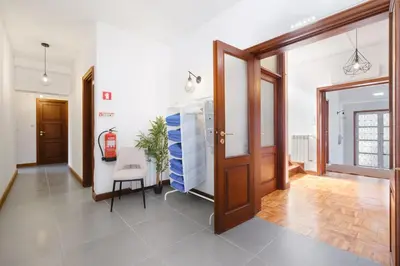 a hallway with a door and a chair in a room at Villa 7BR & 7BA with Pool & Backyard in a Prime Location! in Vila Nova de Gaia