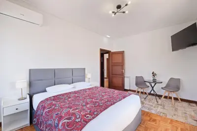 a bedroom with a large bed with a red blanket at Villa 7BR & 7BA with Pool & Backyard in a Prime Location! in Vila Nova de Gaia