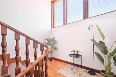 a staircase in a home with a potted plant at Villa 7BR & 7BA with Pool & Backyard in a Prime Location! in Vila Nova de Gaia
