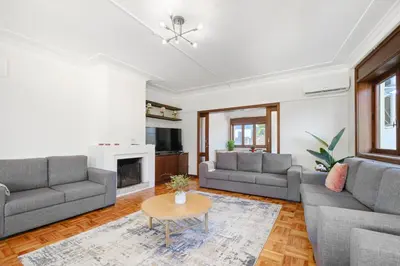 a living room with two couches and a table at Villa 7BR & 7BA with Pool & Backyard in a Prime Location! in Vila Nova de Gaia
