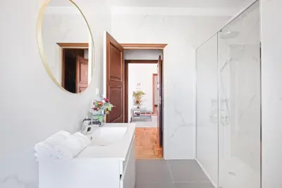 a white bathroom with a sink and a mirror at Villa 7BR & 7BA with Pool & Backyard in a Prime Location! in Vila Nova de Gaia