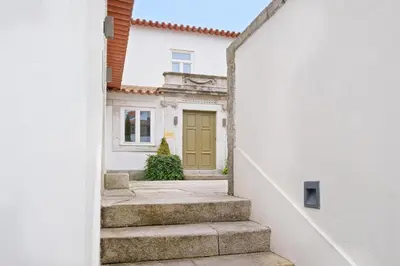 a stairway leading to a house with a green door at City Retreat by Reframe stay in Porto in Porto