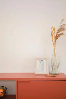a red cabinet with a vase and a picture on it at Liiiving in Gaia - Cooper Residence Apartment I in Vila Nova de Gaia