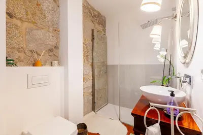 a bathroom with a sink and a shower at Stunning Designer Flat with Balcony Heart of Porto in Porto