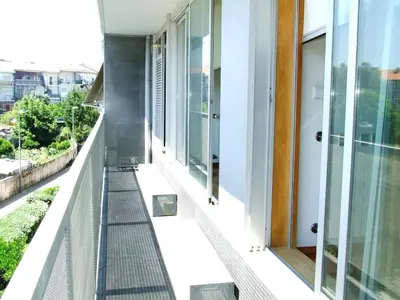 a balcony with a view of a building at Modern and quiet T1 with private Garage in Porto