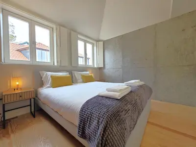 a living room with a table and a couch at Miradouro River Views & Patio by PortoCityHosts in Porto