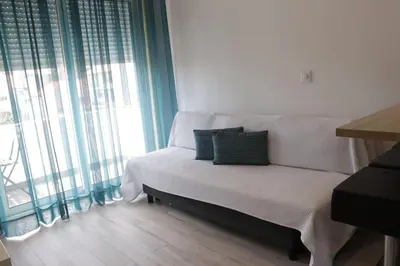 a small bed in a room with a large window at Sweet apartment in Porto in Porto