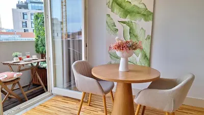 a table and chairs in a room with a balcony at Oporto Hideaway 3 - Poveiros Square Balcony in Porto