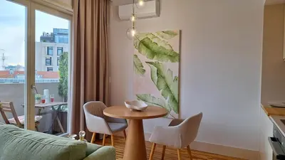 a living room with a table and chairs and a window at Oporto Hideaway 3 - Poveiros Square Balcony in Porto
