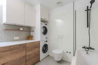 a laundry room with a washer and dryer in it at Stylish Open-Plan Flat with Swimming Pool by HostWise in Porto