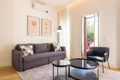 a living room with a couch and a table at Caldeireiros 95 by LovelyStay in Porto
