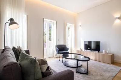 a living room with a couch and a table at Caldeireiros 95 by LovelyStay in Porto