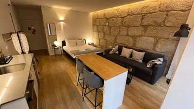 a living room with a couch and a table at Caldeireiros 95 by LovelyStay in Porto