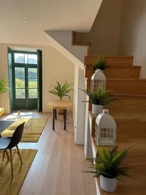 a living room with potted plants and a staircase at Douro Villa 2 -Best View in Town in Vila Nova de Gaia