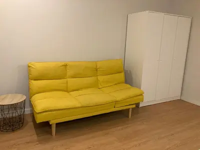a yellow couch in the corner of a room at Douro Villa 3 - Best View in Town in Vila Nova de Gaia