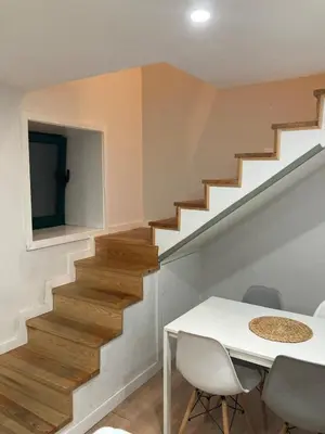 a staircase in a house with a white table and chairs at Douro Villa 3 - Best View in Town in Vila Nova de Gaia