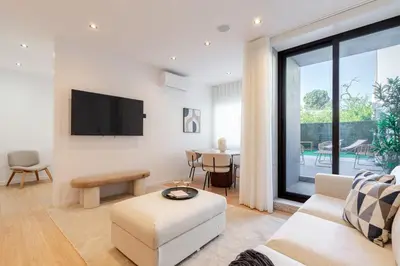 a living room with a couch and a tv at Urban Terrace & Stylish Living Spaces by HostWise in Porto