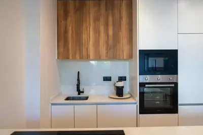 a small kitchen with a sink and a microwave at Urban Terrace & Stylish Living Spaces by HostWise in Porto