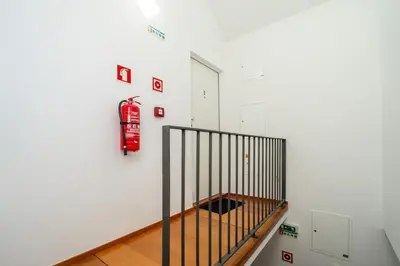 a room with a fire extinguisher on the wall at Modern & Cozy Studio by HostWise in Porto