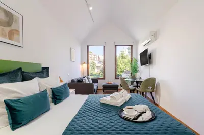 a bedroom with a large bed with blue pillows at Modern & Cozy Studio by HostWise in Porto