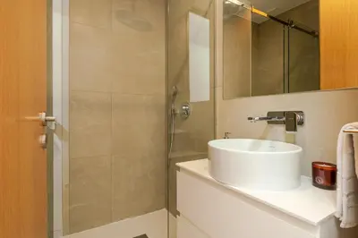a bathroom with a sink and a shower at Modern & Cozy Studio by HostWise in Porto