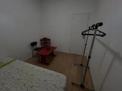 a room with a bed and a tripod next to a door at Casa Carvalho Guest House Porto in Porto