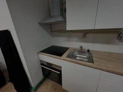 a small kitchen with a sink and a counter at Casa Carvalho Guest House Porto in Porto