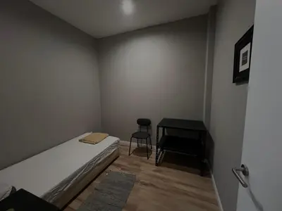 a small bedroom with a bed and a desk at Casa Carvalho Guest House Porto in Porto