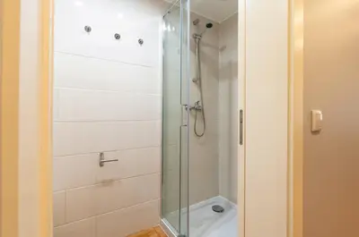 a shower with a glass door in a bathroom at City Views Flats in Historic Porto by HostWise in Porto