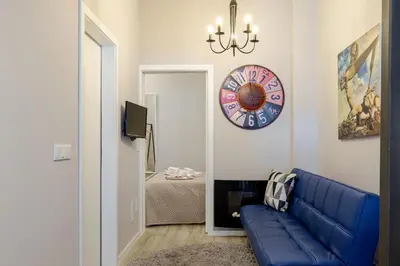 a living room with a blue couch and a clock at City Views Flats in Historic Porto by HostWise in Porto