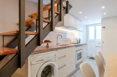 a kitchen with a washer and dryer in a room at City Views Flats in Historic Porto by HostWise in Porto