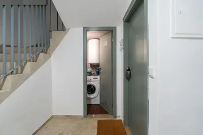 a hallway with a washer and dryer in a house at City Views Flats in Historic Porto by HostWise in Porto